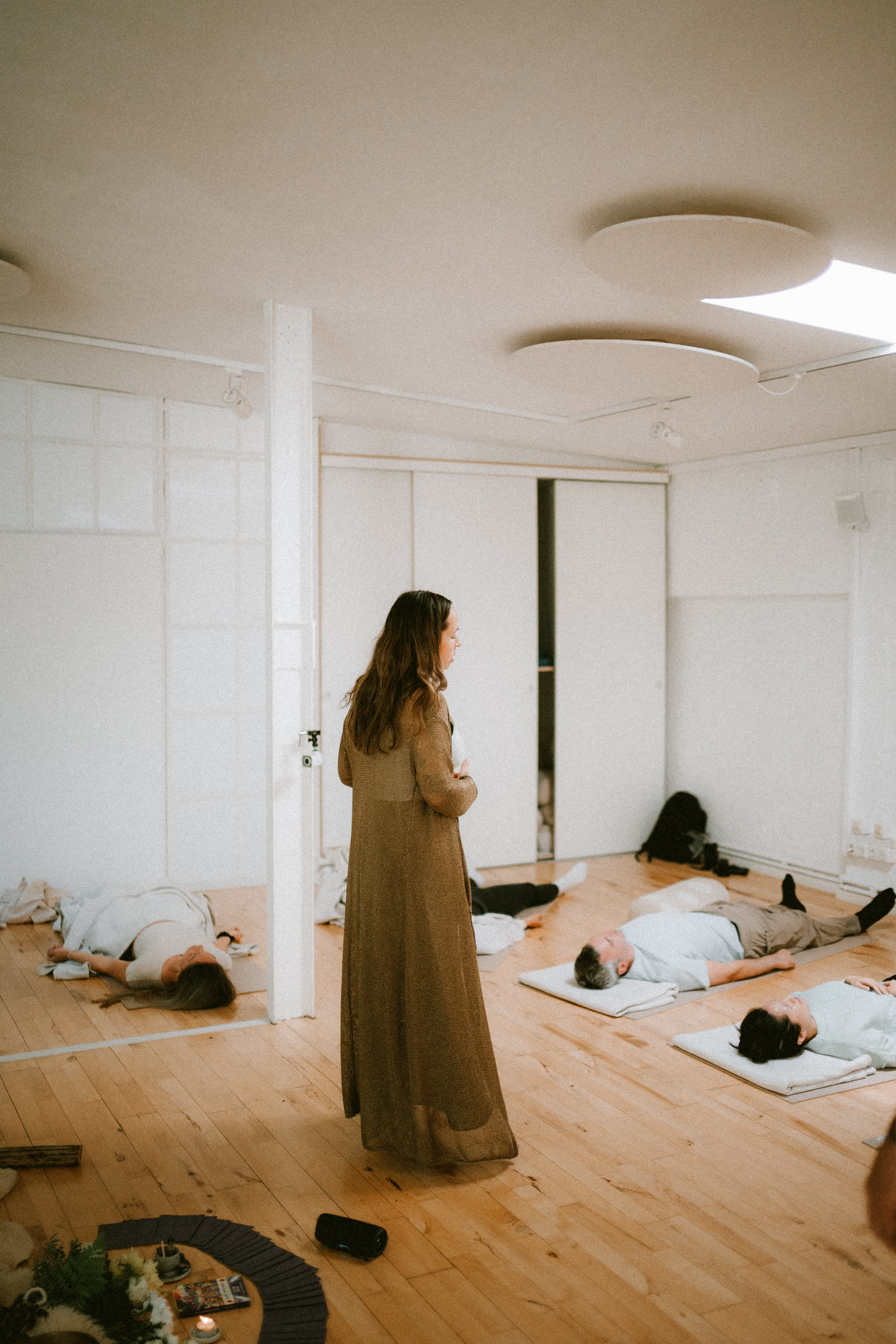 Nic holding the room while a group rests in a breathwork session